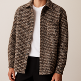Men’s brown textured button-up jacket with houndstooth-inspired weave, worn over a plain white t-shirt.