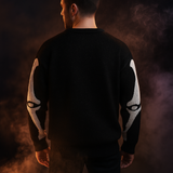 Black knit pullover sweater with white skeleton ribcage and bone pattern, cozy Halloween-themed clothing.