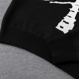 Black knit pullover sweater with white skeleton ribcage and bone pattern, cozy Halloween-themed clothing.