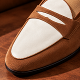 Close-up of Milano suede penny loafer toe in Tan and white