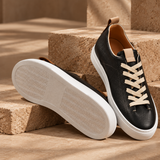 Black Montaro leather sneakers on stone steps, showing sole