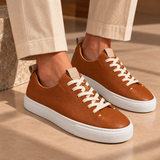 Woman wearing Brown Montaro leather sneakers with cream trousers