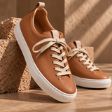 Pair of Brown Montaro leather sneakers on stone blocks