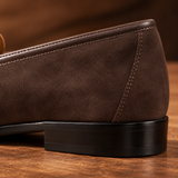 Close-up of Milano Chocolate suede penny loafer heel