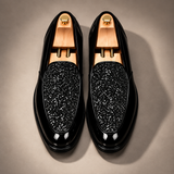 Pair of Roma Lucido glitter patent loafers in Black, on shoe trees