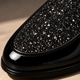 Macro view of the sparkling glitter vamp on Roma Lucido patent loafers in Black