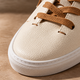 Close-up of toe and tan laces on White Montaro leather sneaker