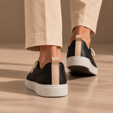 Woman walking in Black Montaro leather sneakers, rear view