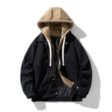 Men’s black corduroy shacket with oversized front pockets and hood, a durable outerwear piece with a sleek rugged edge.