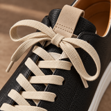 Close-up of cream laces tied on Black Montaro leather sneaker