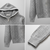 Men’s grey perforated knit zip hoodie designed with breathable fabric, hood, and pockets, offering casual comfort and airflow.